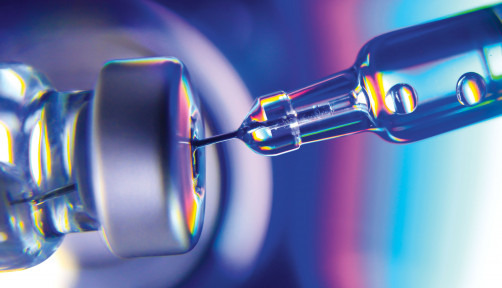 needle going into vial vaccine